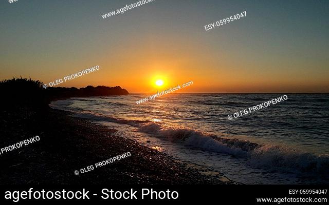 Sunset on the shore of the Agean Sea in Rhodes in the Greece