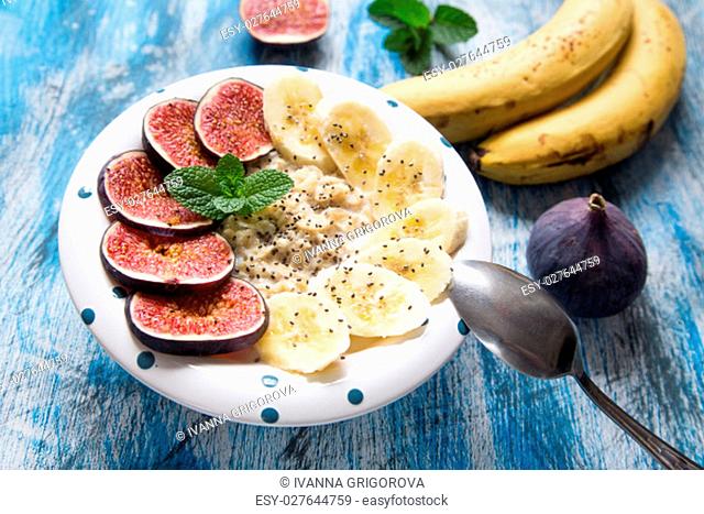 healthy breakfast: oatmeal with fresh figs, bananas, coconut milk and chia seeds