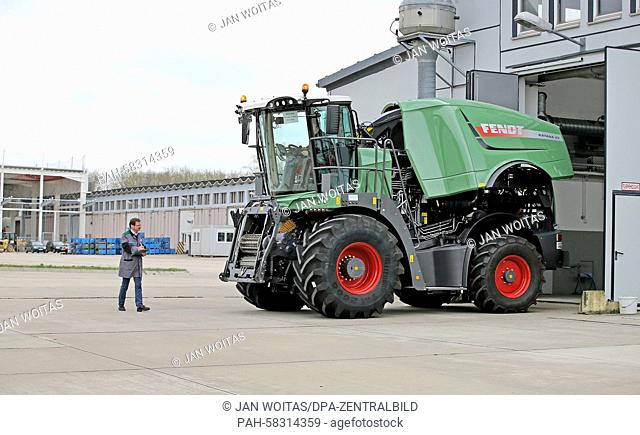 Two employees do the quality check of a Fendt Katana 65 corn chopper in front of a former tank maintenance hall in Hohenmoelsen, Germany, 17 April 2015