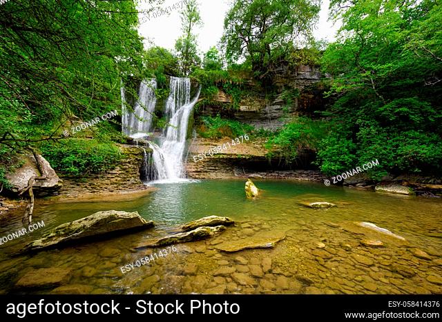 Idyllic rain forest waterfall, stream flowing in the lush green forest. High quality image