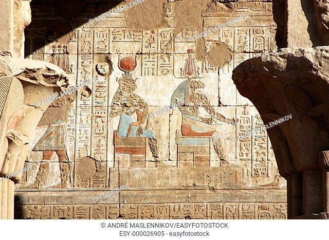 Original hieroglyphs and paintings of Isis in Horus temple in Edfu, Egypt; in the old times, first chistians tried to destroy their faces