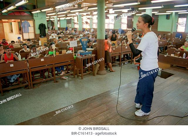 Young singer entertaining workers at the Partagas cigar factory, Havana, Cuba