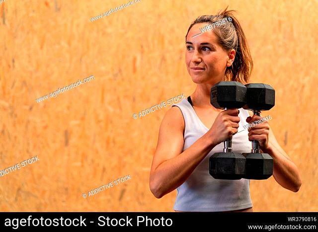 sportswoman, weightlifting, short dumbbell