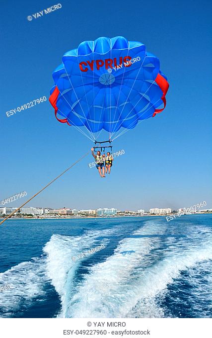 Extreme flight on a parachute over the water high in the sky
