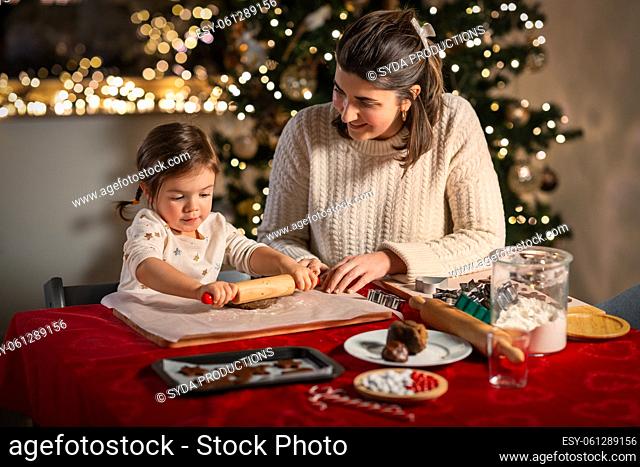 mother and daughter making gingerbread at home