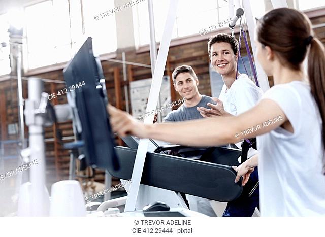 Physical therapists with man on treadmill