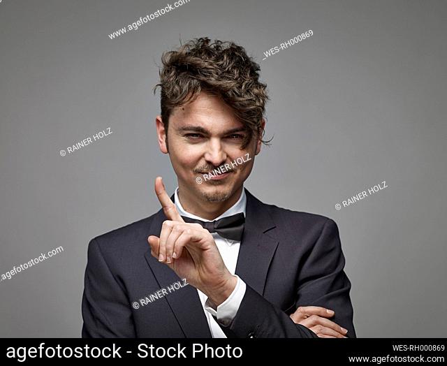 Portrait of man with outstretched index finger