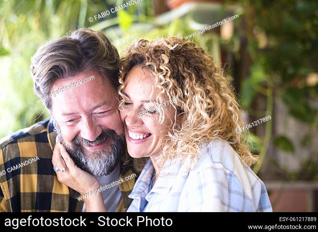 Happy romantic couple smiling and hugging each other with love. Close up of romantic couple spending leisure time outdoors