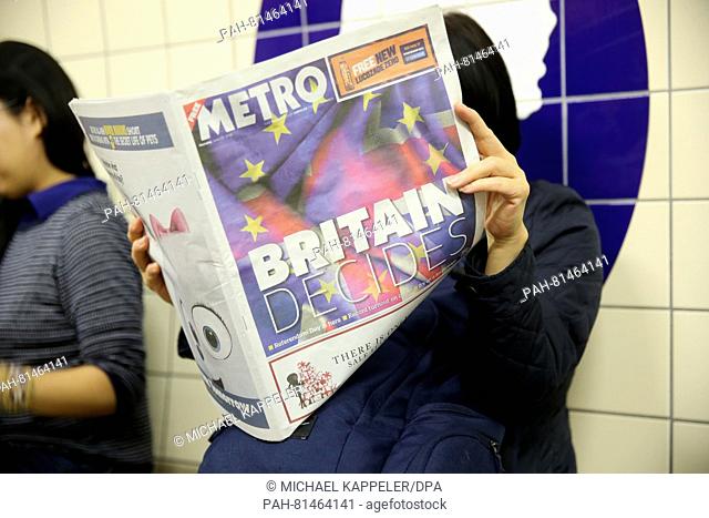 A woman reads the free leaflet 'Metro' that reads 'Britain decides' in a London Underground station in London,  Britain, 23 June 2016