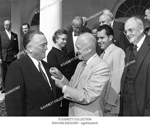 President Eisenhower presents the National Security Medal to FBI Director J. Edgar Hoover. Ceremony attended by a Cabinet group which included: Oveta Culp Hobby