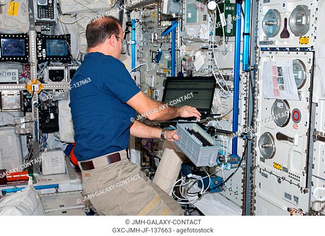 NASA astronaut Rick Mastracchio, Expedition 38 flight engineer, works with Biolab hardware in the Columbus laboratory of the International Space Station