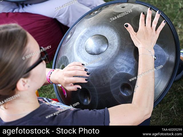 RUSSIA, MOSCOW - JULY 2, 2023: A woman with a hang drum is seen during Yoga Day Russia 2023, a yoga festival marking the International Day of Yoga