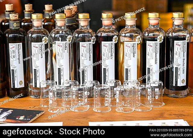 08 October 2020, Berlin: In the showroom of the Deutsche Spirituosen Manufaktur, bottles with various distillates and beakers are set up for tasting