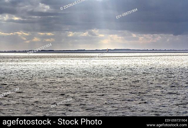 dramatic illuminated coastal scenery near Neuharlingersiel in Eastern Frisia, Germany