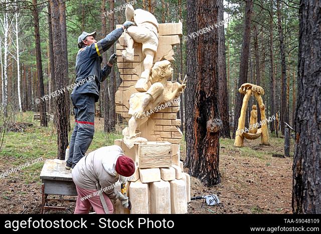 RUSSIA, IRKUTSK REGION - MAY 13, 2023: Participants in the 10th Lukomorye Na Baikale international wood sculpture festival