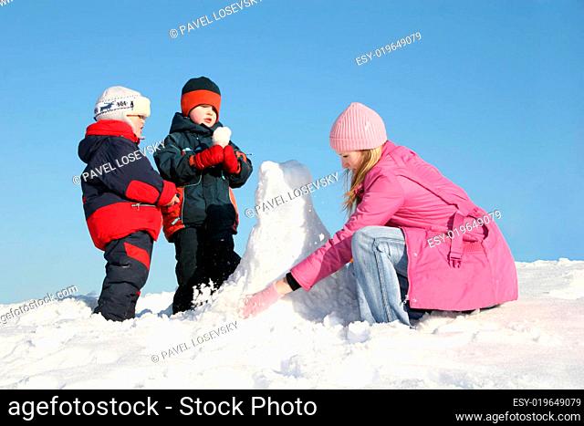 mother with children play on snow