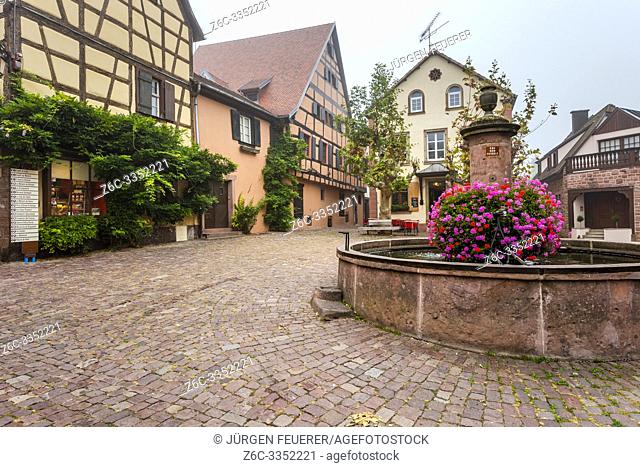 one of many flower-bedecked wells in the village Riquewihr, Alsace Wine Route, France, square of the village