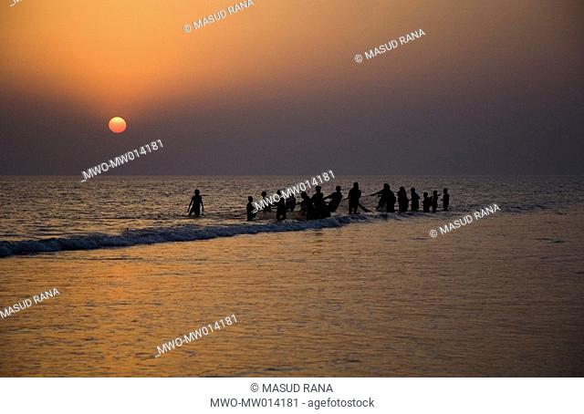Fishermen pulling up a net at the Kuakata beach in Patuakhali, Bangladesh Kuakata, locally known as ‘Sagar Kannya’ or daughter of the sea