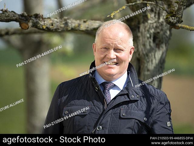 03 May 2021, Hessen, Ober-Erlenbach: Karsten Schmal, President of the Hessian Farmers' Association, stands at the edge of a field during a press event organised...