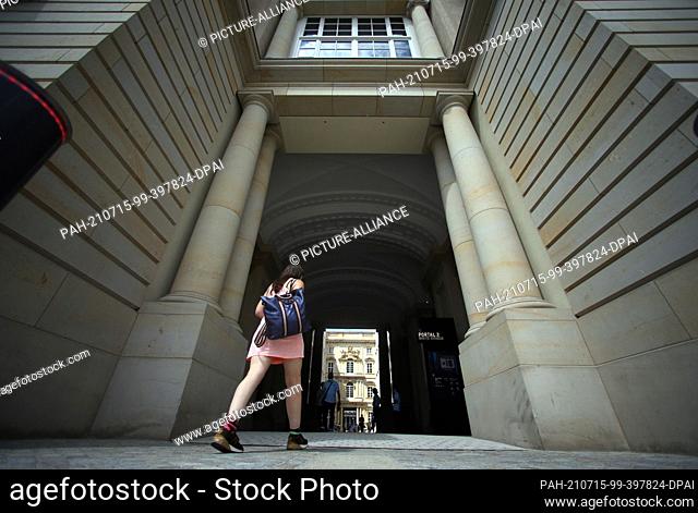 15 July 2021, Berlin: People walk through a portal into the Schlüterhof of the Humboldt Forum. The rebuilt Berlin City Palace opens on July 20 with several...