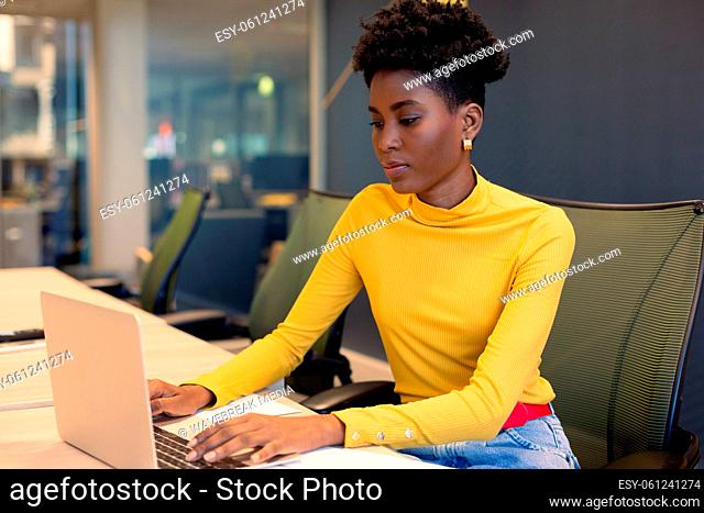 African american young businesswoman using laptop while working at modern office