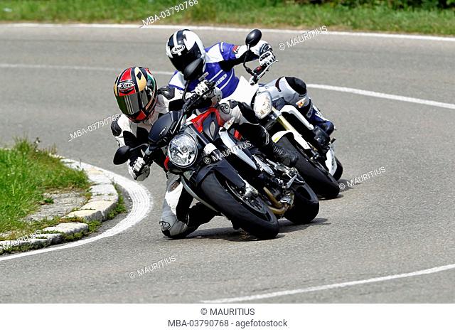 Motorcycles, three-cylinder engine MV Agusta Brutale 675, Triumph Streettriple, year of construction in 2012, one after the other in a curve