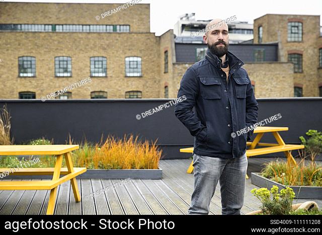 Portrait of man on rooftop patio