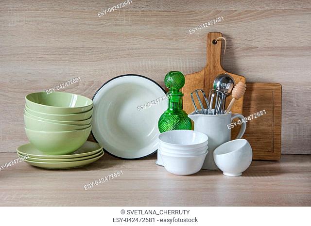 Crockery, tableware, utensils and other different stuff on wooden table-top. Kitchen still life as background for design. Image with copy space