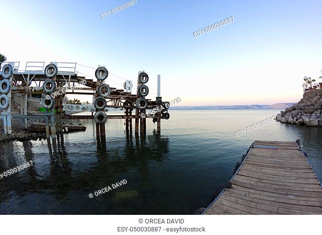 dock's on the sea of galilee at sunset with hte golan hights in the background