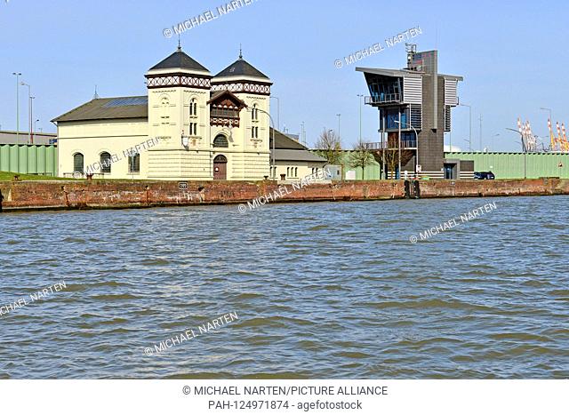 The historic and the current operating building from the lock Kaiserschleuse in Bremerhaven by the quay wall of the harbour Kaiserhafen