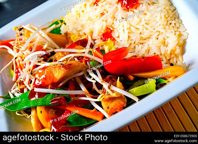 fried sweet and sour chicken with vegetables