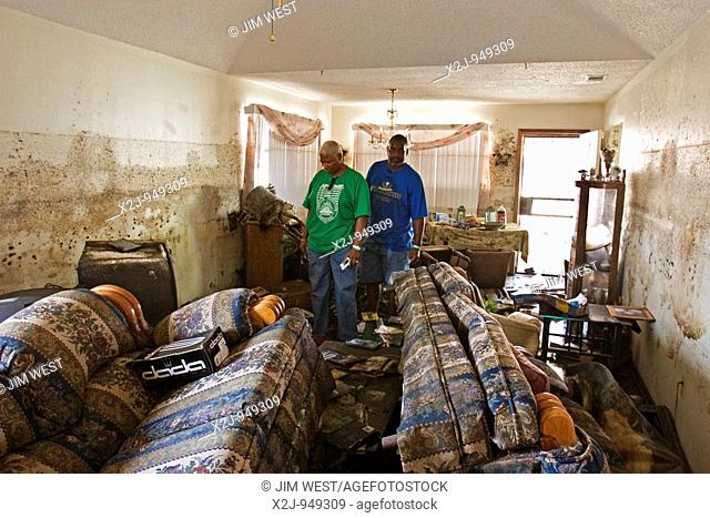 New Orleans, Louisiana - September 18, 2005 - Michele Baker and her husband Alexander inspect the Hurricane Katrina devastation of their home  Note the water...