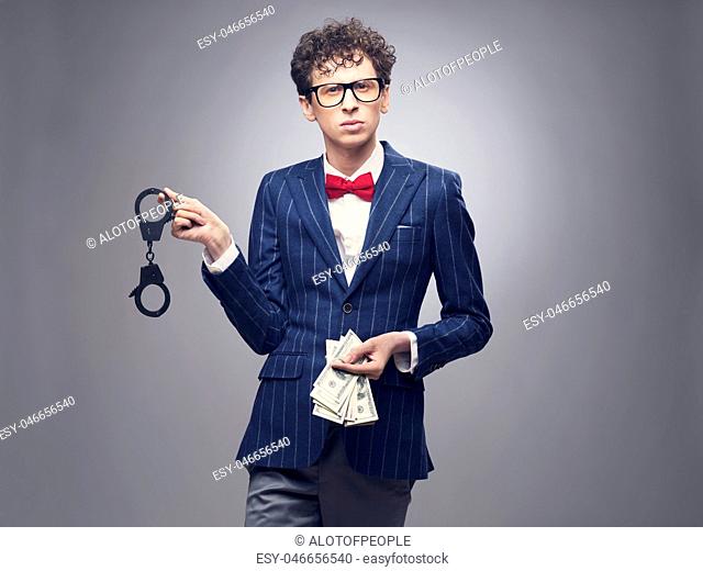 Man with handcuffs and money