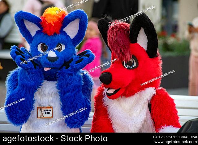 23 September 2023, Mecklenburg-Western Pomerania, Binz: With colorful animal costumes, participants of the ""Furry Treffen"" sit on the spa square