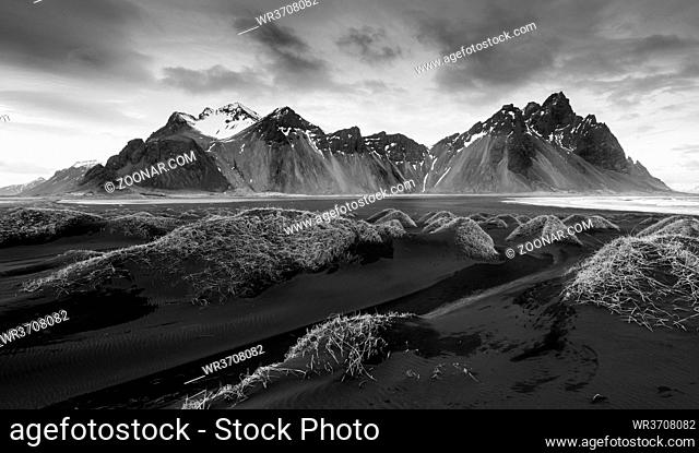 Black and white image of Icelandic Landscape Southern Iceland, Hofn, Stokksnes peninsula with the famous Vestrahorn Mountains and dramatic sky