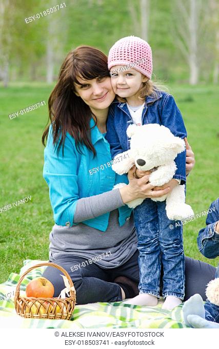 Incomplete family - mother, five-year and three year old daughter at a picnic