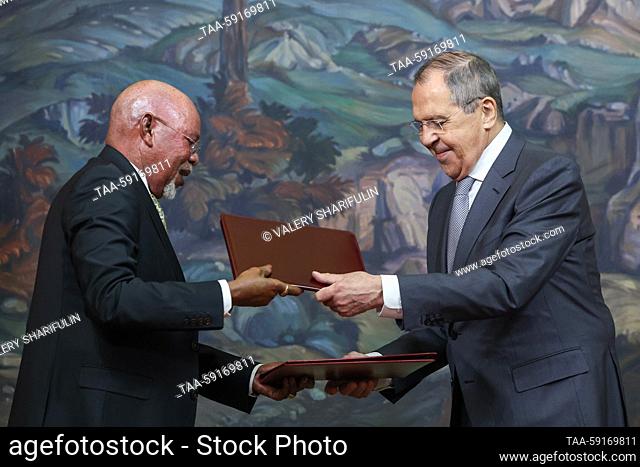 RUSSIA, MOSCOW - MAY 18, 2023: Uganda's Foreign Minister Jeje Odongo (L) and his Russian counterpart Sergei Lavrov sign an agreement on non-deployment of...