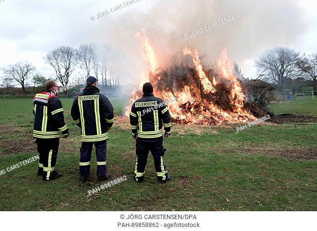 An Easter Fire is lit by voluntary firefighters in Niehuus, Germany, 13 April 2017. Photo: Jörg Carstensen/dpa | usage worldwide