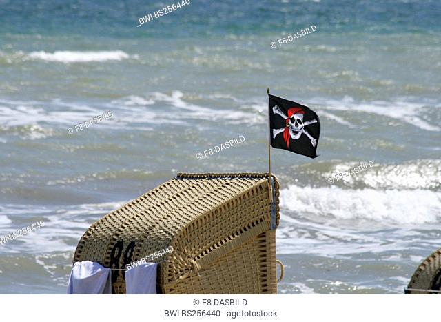 pirate flag on roofed wicker beach chair, Germany, Schleswig-Holstein, Dahme