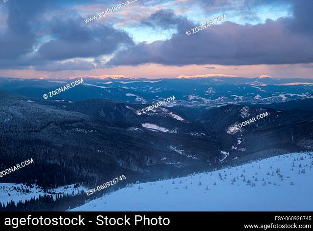 Picturesque winter alps windy day sunrise. Panoramic mountains view from Svydovets ridge and Dragobrat ski resort