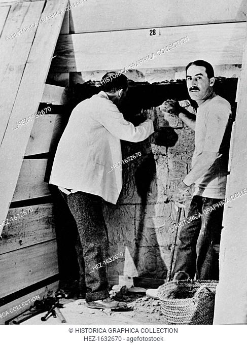 Howard Carter and a colleague excavating a tomb in the Valley of the Kings, Egypt, 1922. Carter's (1873-1939) discovery of Tutankhamun's tomb in 1922 was one of...