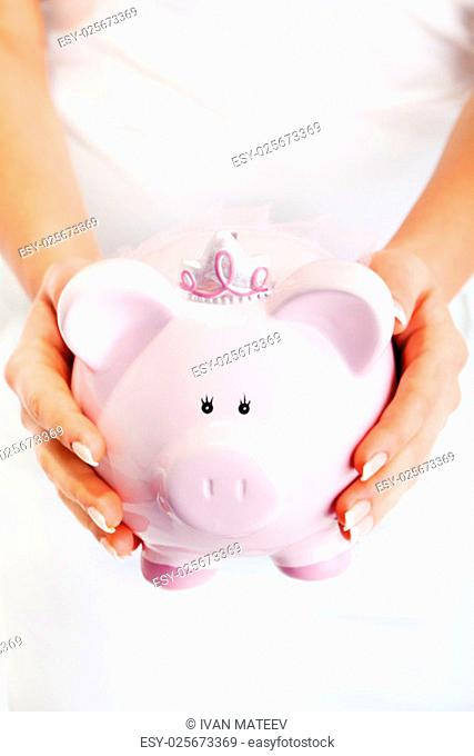 Young woman holding pink pig money-box - Piggy Bank