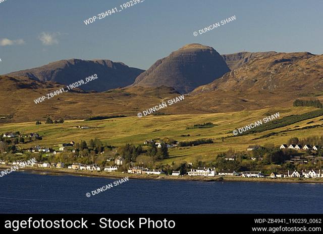 Lochcarron village, on the shore of Loch Carron, looking up to the Applecross hills. Prominent in the centre is Sgurr a Ghaorachain (776 metres)