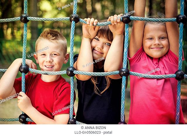 Happy children holding a net on playground, Debica, Poland