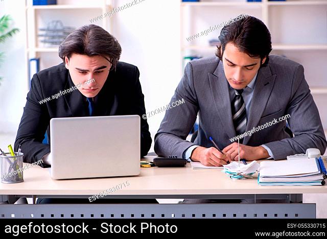 The two young employees working in the office