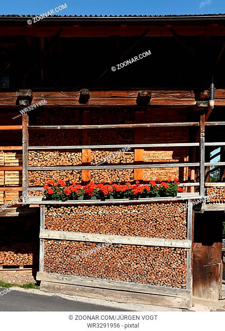 Bauernhaus; Holzhaus; in Colfosco; Dolomiten; Suedtirol; timber house; stacked firewood; wooden pile;