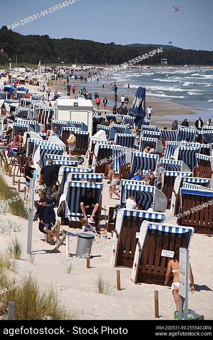 31 May 2020, Mecklenburg-Western Pomerania, Binz: Tourists enjoy the Whitsun weekend on the beach. Lively north-easterly winds have brought joy to surfers and...