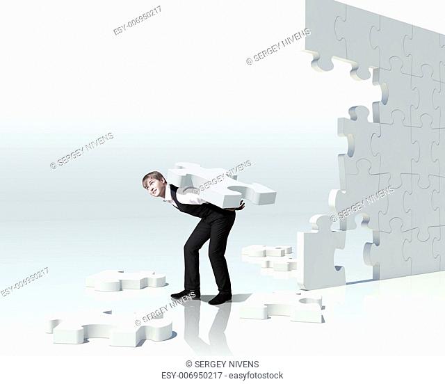 Businessman with a puzzle pieces on the background