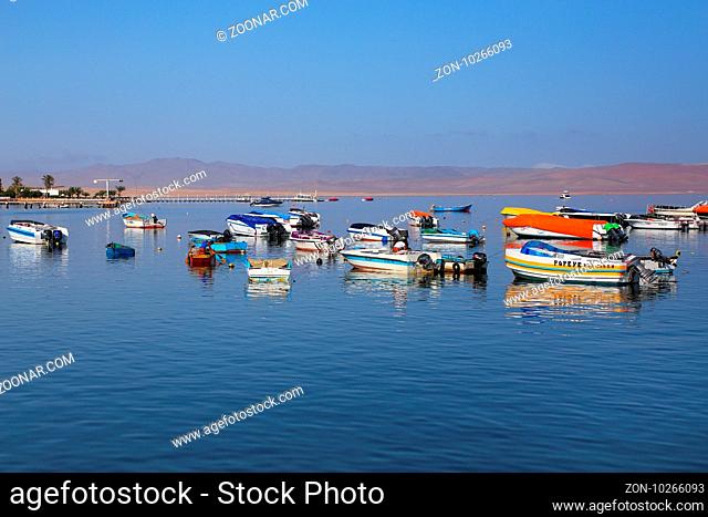 Small motorboats anchored in Paracas Bay, Peru. Paracas is a small port town catering to tourists visiting Paracas Reserve and Ballestas islands