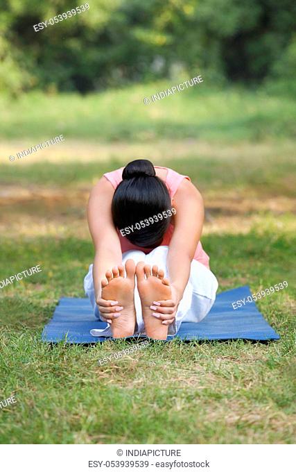 Woman stretching in lawn